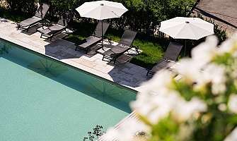 Relaxing pool area with sun loungers