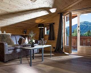 A stylish chalet living room with wooden decor and a view.