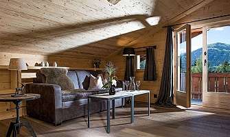 Bright living room with wooden decor and a view of the mountains.