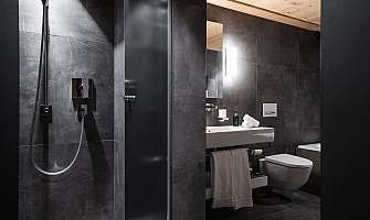 Elegant bathroom with shower, sink and toilet.