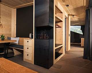 Bright wooden apartment with a cosy seating area and fireplace.