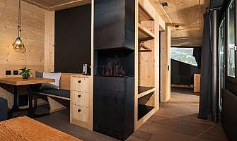 Cozy living area with wooden paneling and modern fireplace.