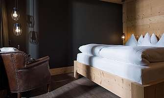 A stylish bedroom with a bed and a leather armchair.