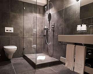 Elegant bathroom with shower, sink and toilet.