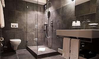 Elegant bathroom with shower, sink and toilet.
