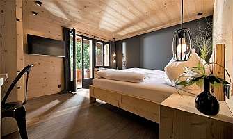 Bright bedroom with wooden decor and balcony access.