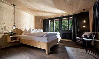 Cozy bedroom with wooden decor and a view of the river