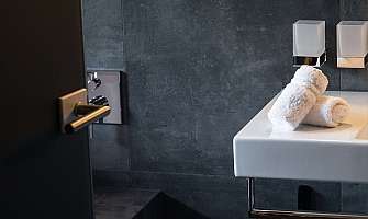 Elegant bathroom view with white towels on the sink.
