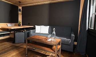 Cozy room with sofa, table and wooden details.