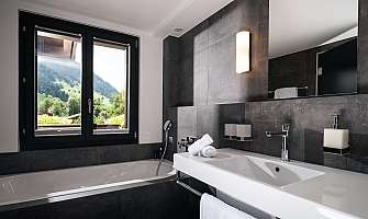 Elegant bathroom with bathtub and mountain view.