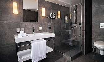 Elegant bathroom with sink, shower, and modern fittings.