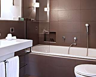Elegant bathroom with sink, bathtub and towels.