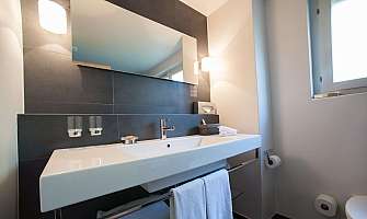 Bright bathroom with elegant sanitary fittings and towels.