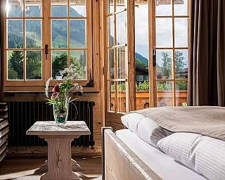 Bright room with a view of the mountains and a plant arrangement.