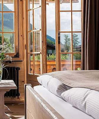 Bright room with a view of the mountains and a plant arrangement.