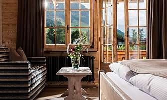 Bright room with a view of the mountains and a plant arrangement.
