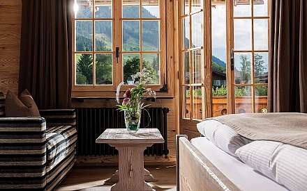 Bright room with a view of the mountains and a plant arrangement.