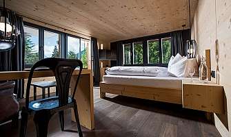 Bright bedroom with wooden decor and mountain panorama